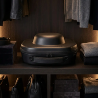 Voyager Hat Travel Case on a dark wood shelf