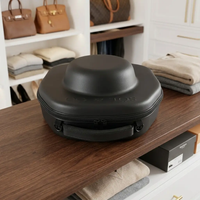 Voyager Hat Travel Case resting on a walnut table in a dressing room