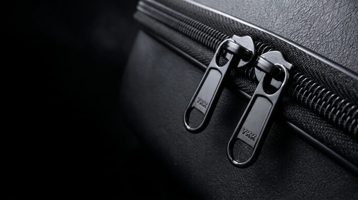 Twin YKK zipper pulls on the Voyager Hat Travel Case's vegan leather shell